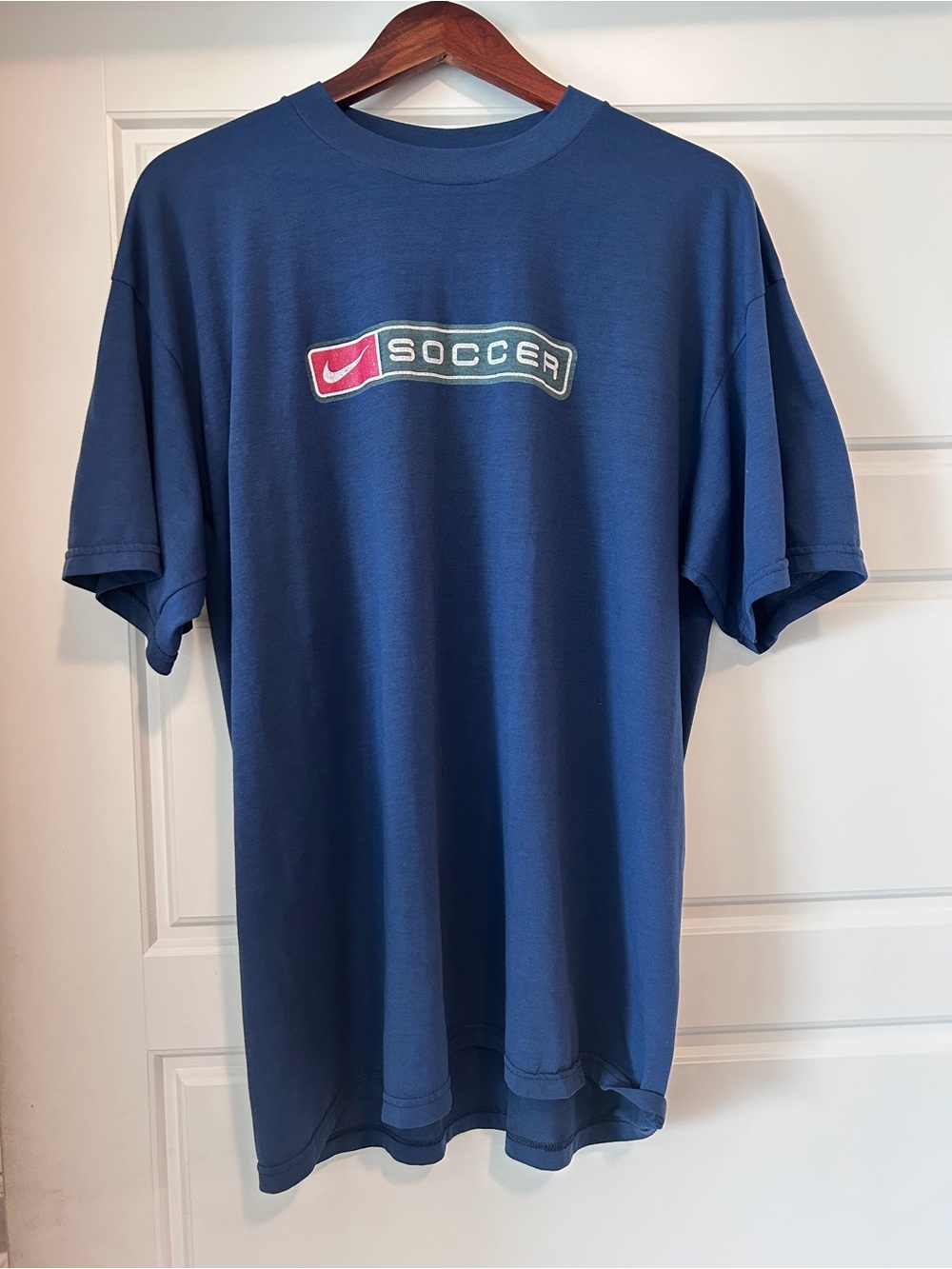 Nike Blue Soccer Logo T-Shirt with Red Accent